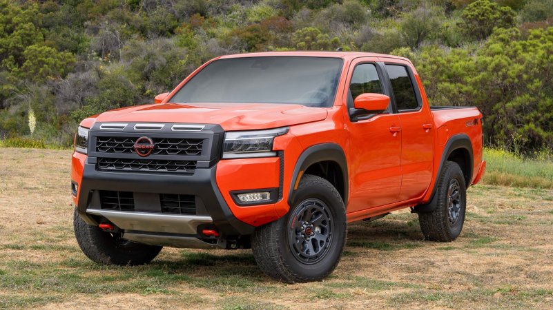 2025 Nissan Frontier front three-quarter view in orange.