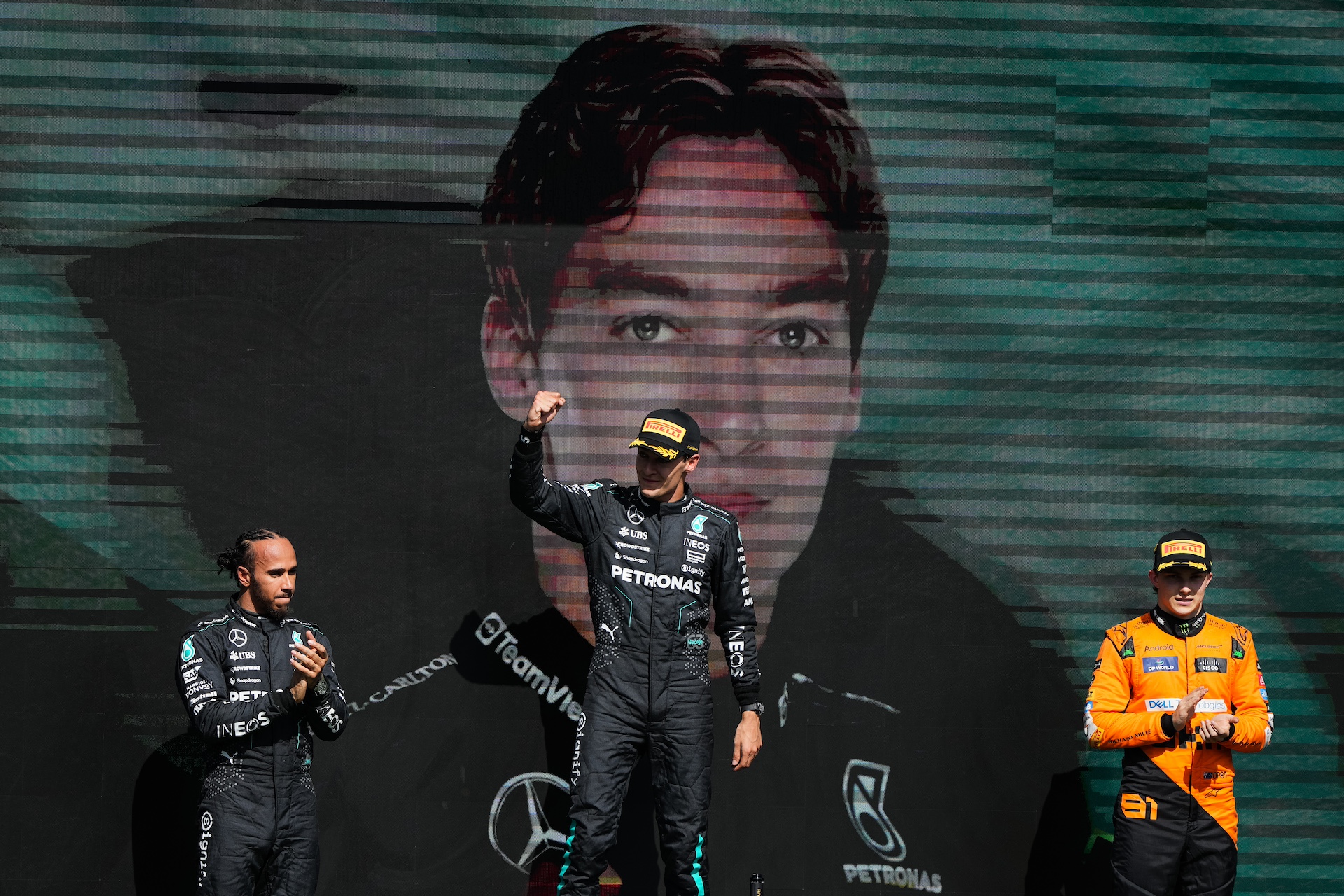 SPA, BELGIUM - JULY 28: 1st placed George Russell of Great Britain and Mercedes, later disqualified for a car weight infraction, (C), Second placed finisher, later promoted to Race winner Lewis Hamilton of Great Britain and Mercedes (L) and Third placed finisher Oscar Piastri of Australia and McLaren, later promoted to Second placed, (R) celebrate on the podium during the F1 Grand Prix of Belgium at Circuit de Spa-Francorchamps on July 28, 2024 in Spa, Belgium. (Photo by Alex Bierens de Haan/Getty Images)