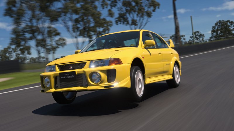 Yellow Mitsubishi Lancer Evo displaying front-wheel hopping glitch in Gran Turismo 7.