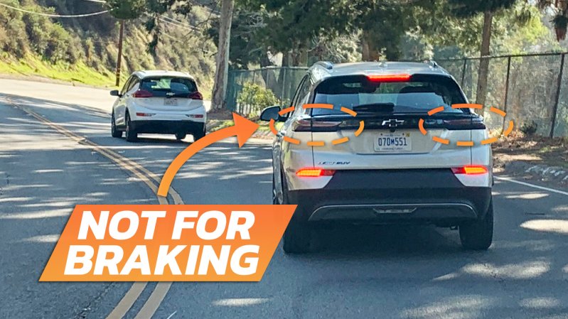 Image of the rear of a 2022-2023 Chevrolet Bolt braking in the daylight, where you can see the upper taillights aren't lit and the actual brake lights are near the bottom of the bumper.