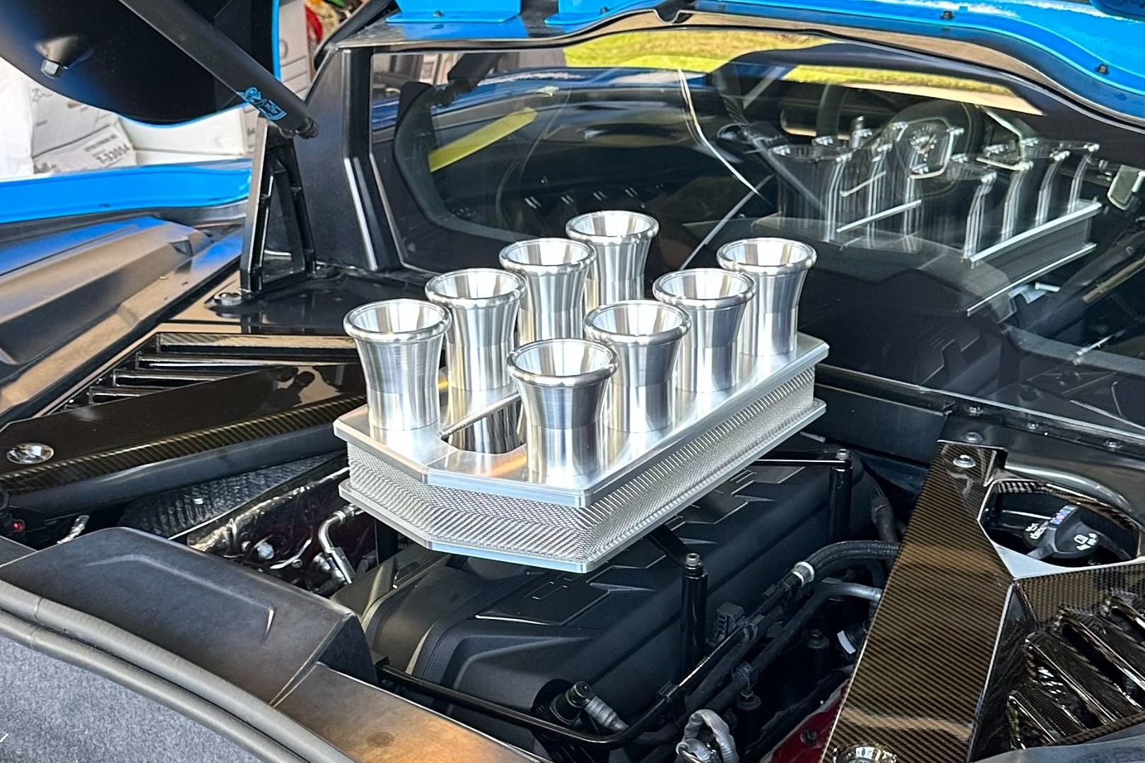 Fake velocity stacks and independent throttle bodies on a C8 Corvette engine cover.