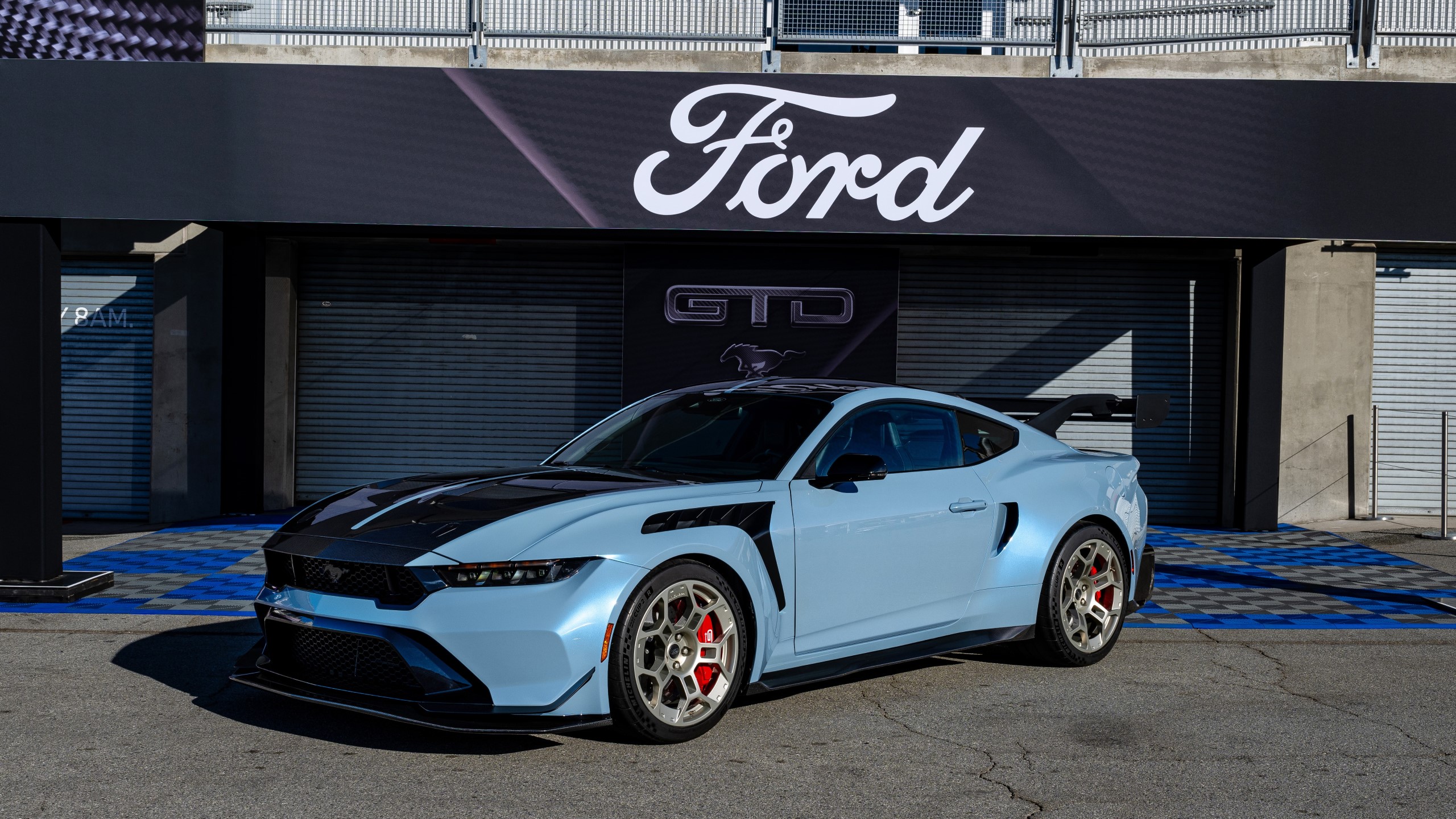 Ford Mustang GTD parked in front of a Ford garage.