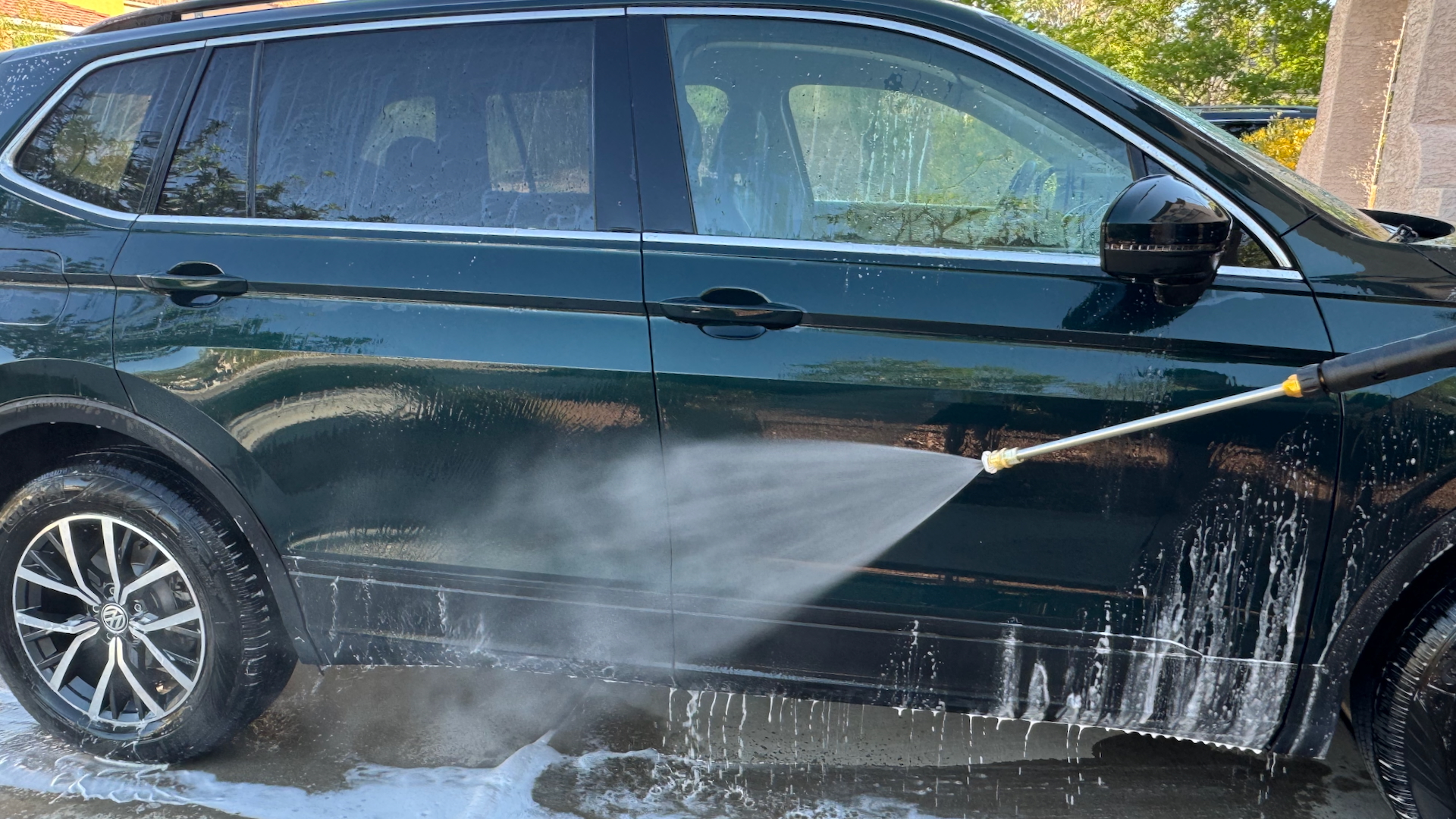 Washing a car with a DeWalt electric pressure washer.