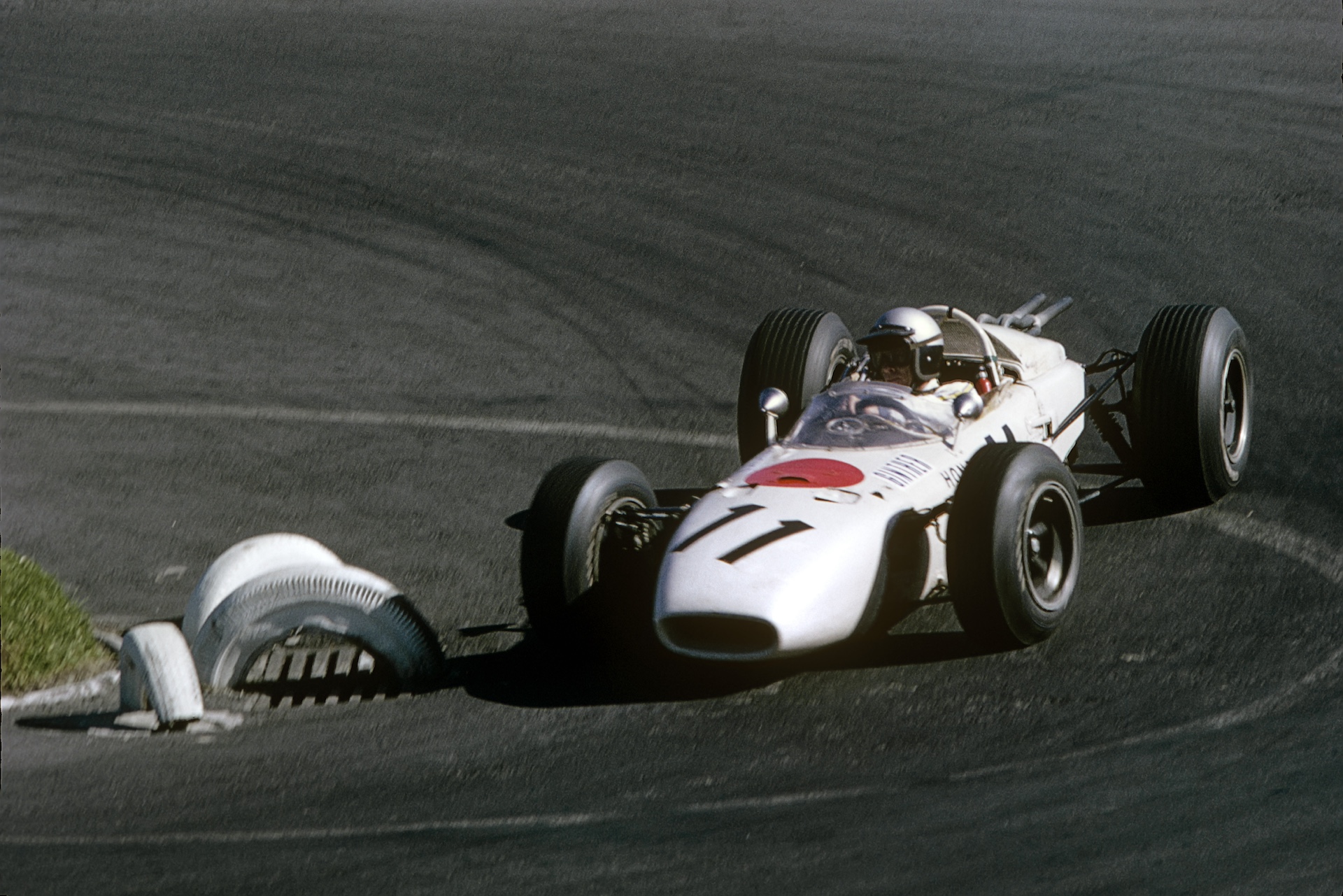 Richie Ginther, Honda RA272, Grand Prix of Mexico, Autodromo Hermanos Rodriguez, Magdalena Mixhuca, 24 October 1965. Richie Ginther driving his Honda RA272 to a historic victory (first victory for Ginther, Honda and Goodyear) in the 1965 Mexican Grand Prix. (Photo by Bernard Cahier/Getty Images)