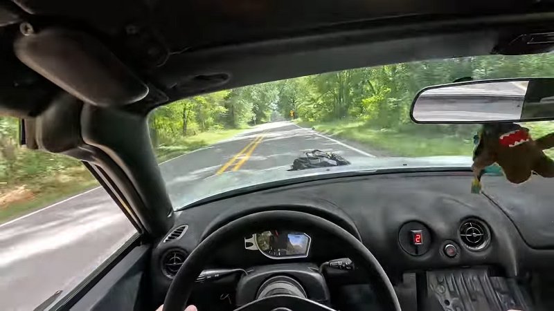 View from driver's seat of Mazda Miata with motorcycle engine.