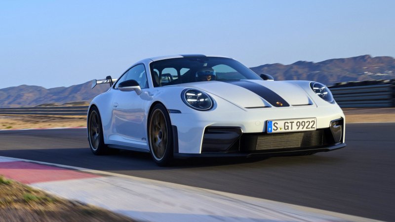 Front three-quarter view of white 2025 Porsche 911 GT3 on track.