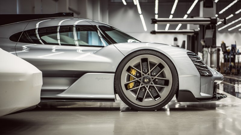 Porsche 919 Street side view focus on front wheel, in garage.