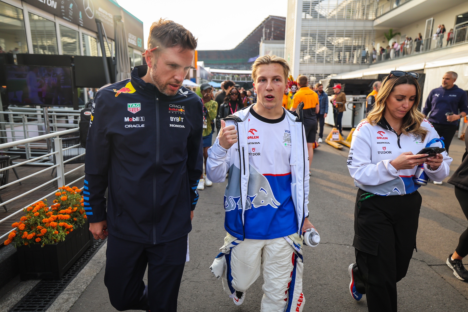 MEXICO CITY, MEXICO - OCTOBER 27: Liam Lawson of New Zealand and Visa Cash App RB talks with Red Bull Racing's head of communications Paul Smith in the paddock during the F1 Grand Prix of Mexico at Autodromo Hermanos Rodriguez on October 27, 2024 in Mexico City, Mexico. (Photo by Kym Illman/Getty Images)