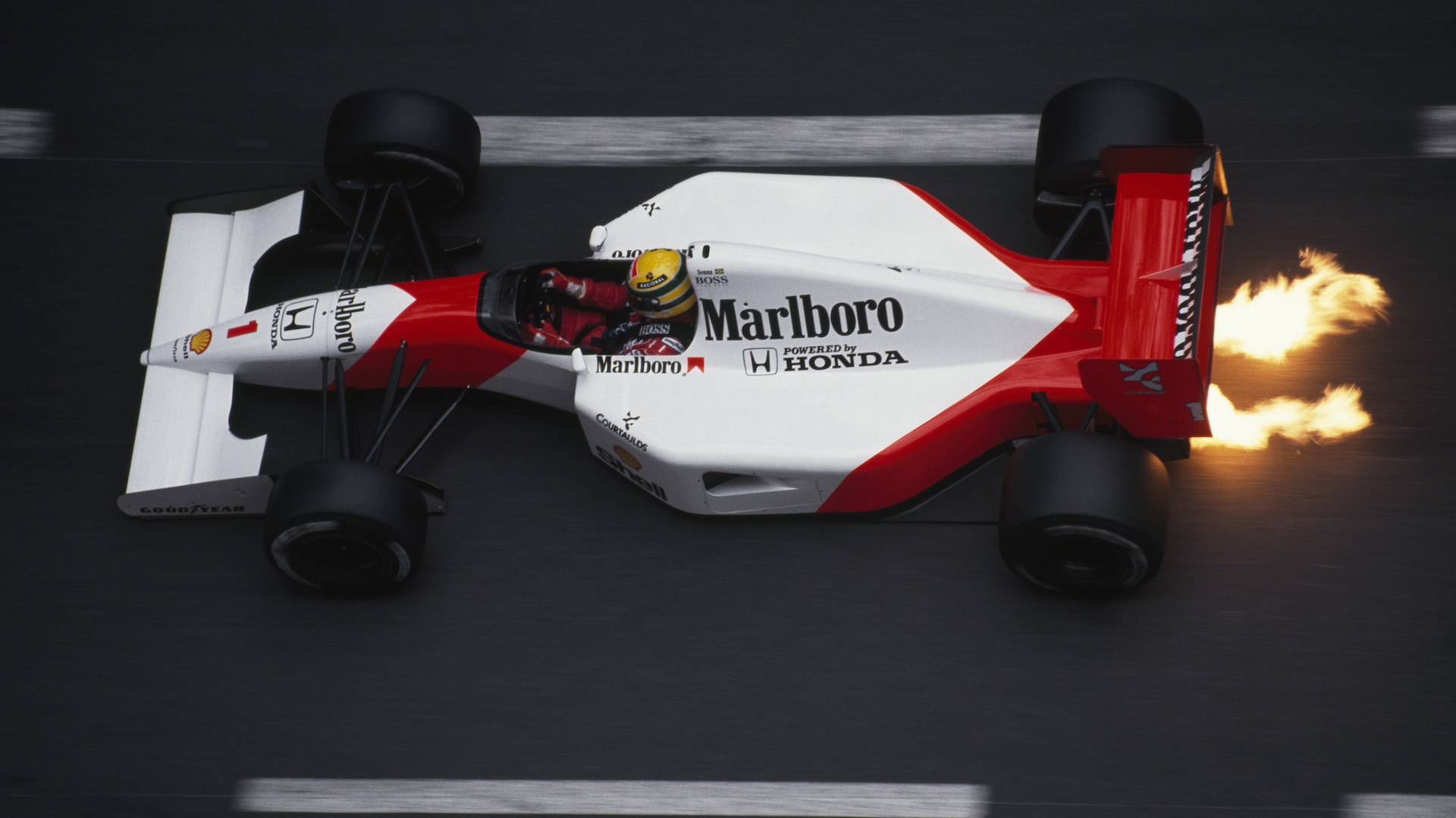 Flames shoot out from under the Formula One racecar of driver Ayrton Senna, of the McLaren-Honda racing team, during the 1991 Monaco Grand Prix. (Photo by Patrick Behar/Corbis via Getty Images)