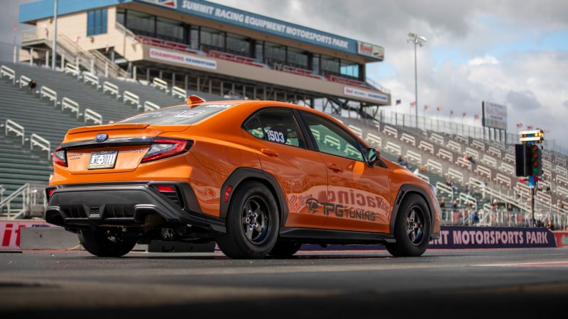 Subaru WRX about to launch on a drag strip.