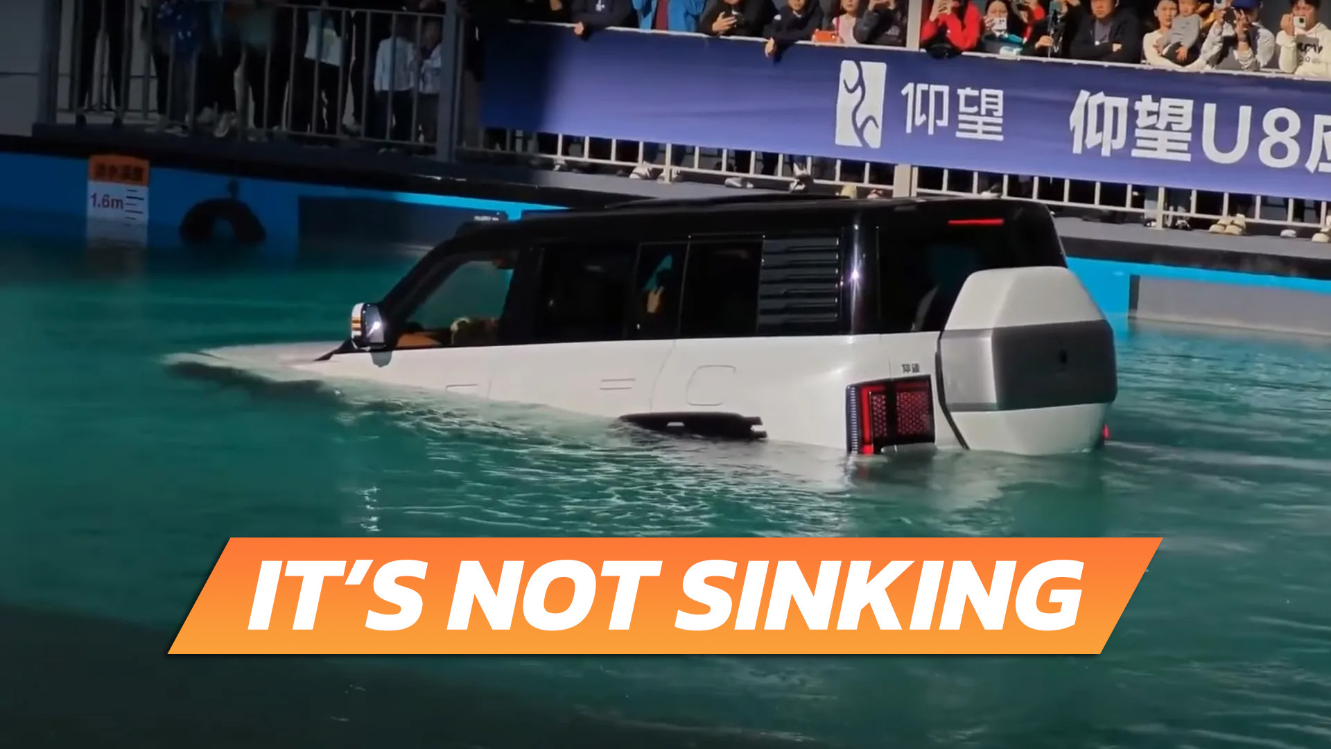 A BYD YangWang U8 floats in a pool of water, while the text "It's Not Sinking" is superimposed.