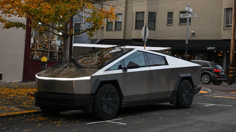 Tesla Cybertruck parked on city street in the fall.