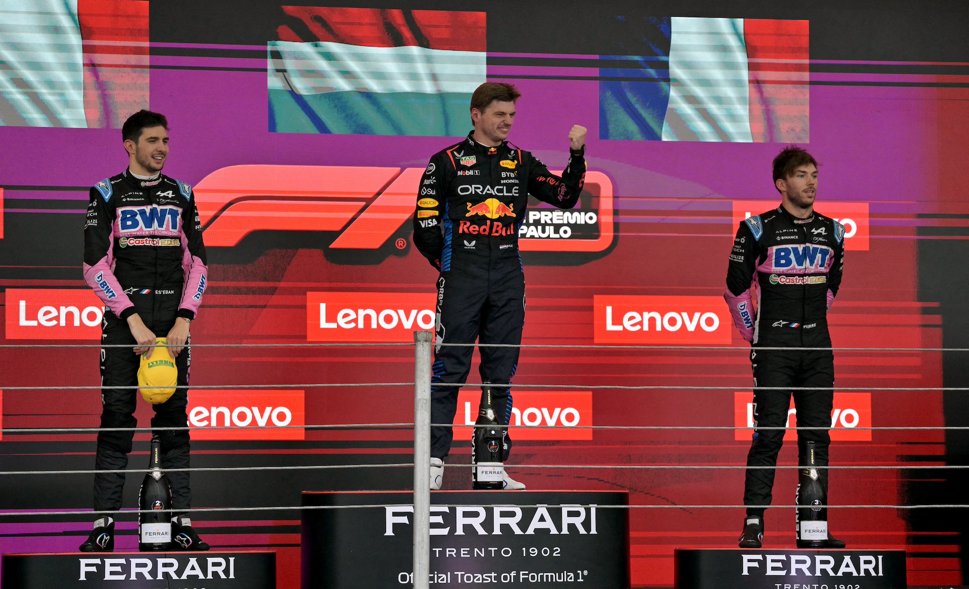 Red Bull Racing's Dutch driver Max Verstappen celebrates flanked by Alpine's French drivers Esteban Ocon (L) and Pierre Gasly, at the podium of the Formula One Sao Paulo Grand Prix, at the Jose Carlos Pace racetrack, aka Interlagos, in Sao Paulo, Brazil, on November 3, 2024. (Photo by NELSON ALMEIDA / AFP)