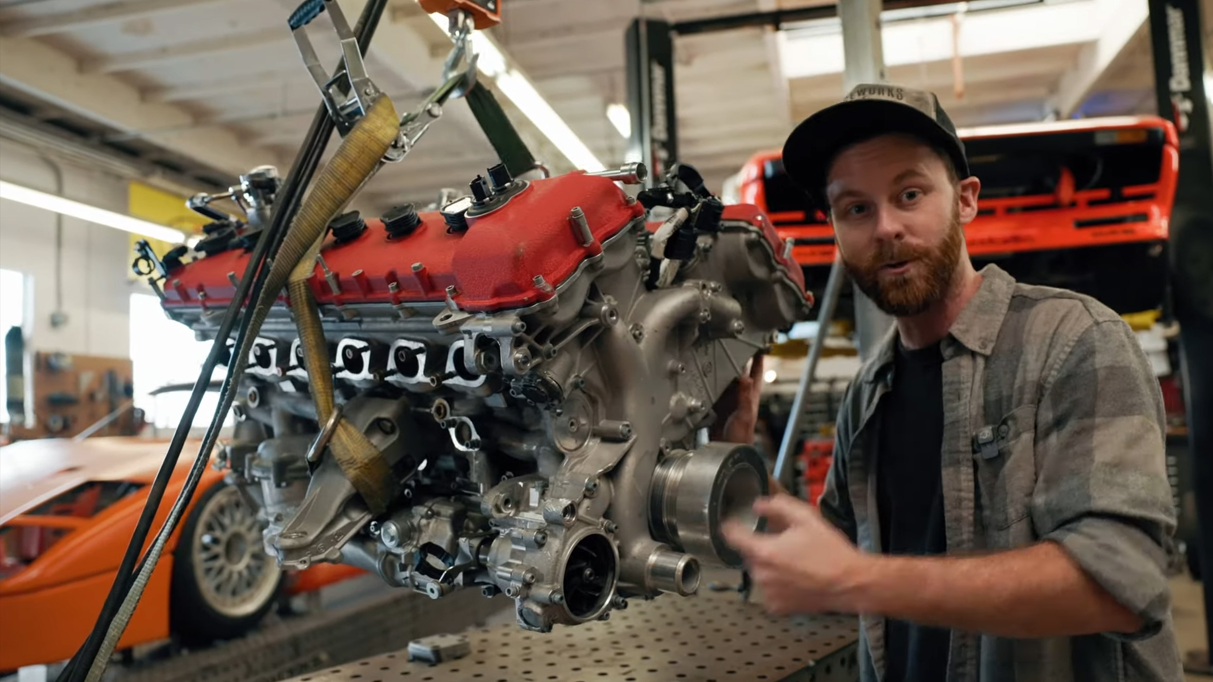 StanceWorks' Mike Burroughs stands next to the F140 V12 engine he purchased, and talks about it to camera.