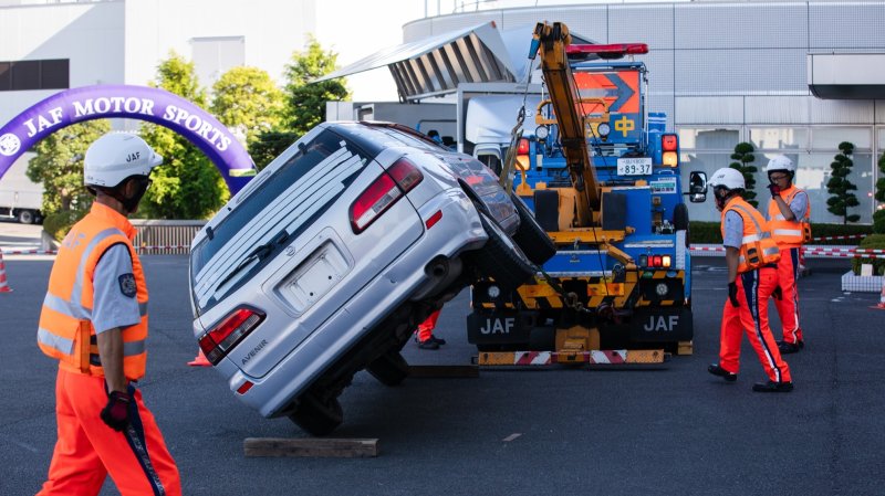 Japanese tow truck putting a car back on its wheels