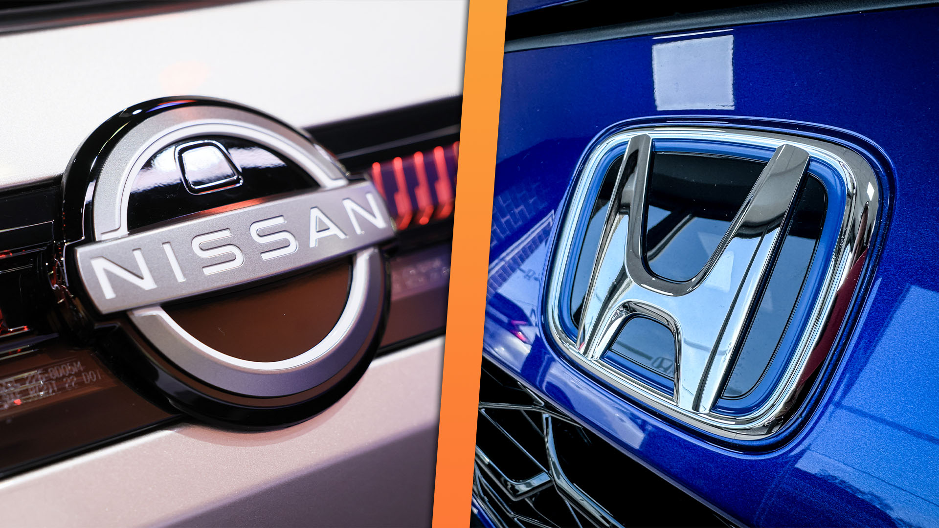 Nissan and Honda badges side by side, close up