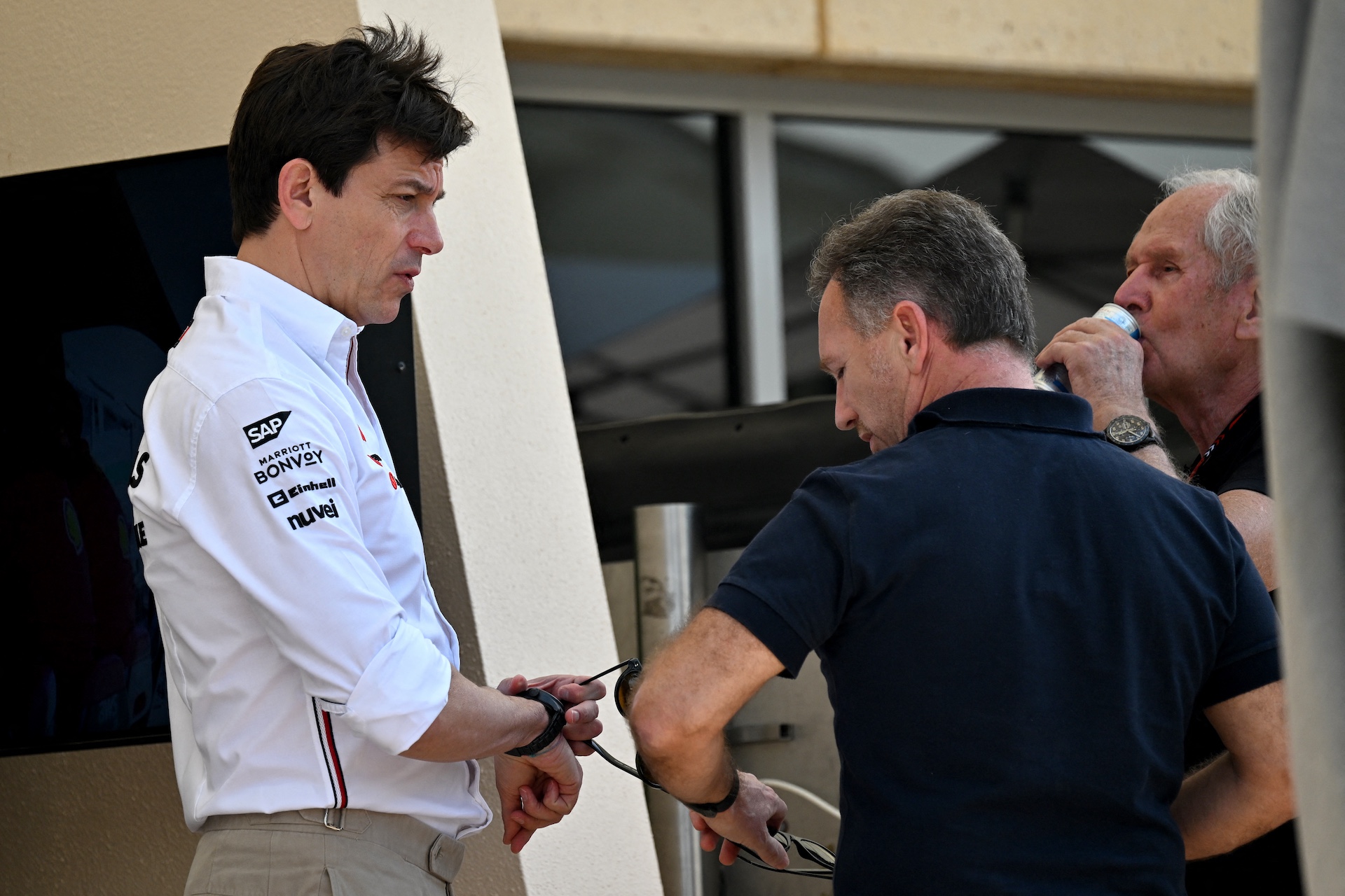 Mercedes AMG Petronas F1 Team's team principal Toto Wolff (L) talks to Red Bull Racing's team principal Christian Horner (C) and Red Bull Racing's team advisor Helmut Marko during the third day of the Formula One pre-season testing at the Bahrain International Circuit in Sakhir on February 23, 2024. (Photo by Andrej ISAKOVIC / AFP)