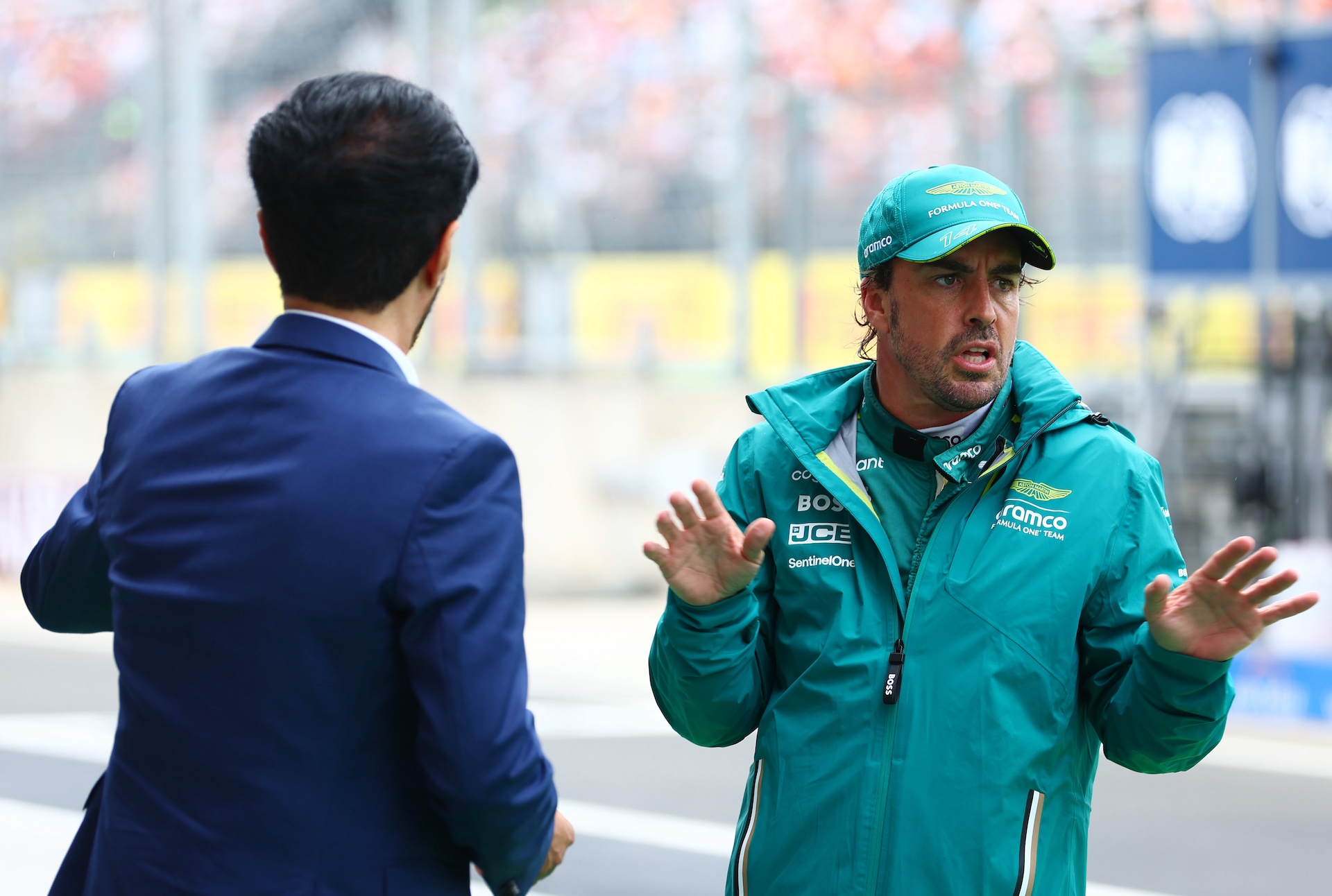 BUDAPEST, HUNGARY - JULY 20: 7th placed qualifier Fernando Alonso of Spain and Aston Martin F1 Team talks with Mohammed ben Sulayem, FIA President, in the Pitlane during qualifying ahead of the F1 Grand Prix of Hungary at Hungaroring on July 20, 2024 in Budapest, Hungary. (Photo by Bryn Lennon - Formula 1/Formula 1 via Getty Images)