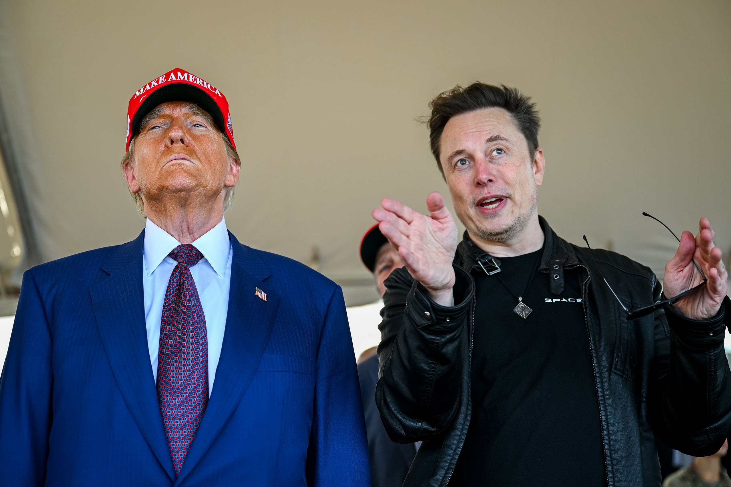 BROWNSVILLE, TEXAS - NOVEMBER 19: Elon Musk speaks with U.S. President-elect Donald Trump as they watch the launch of the sixth test flight of the SpaceX Starship rocket on November 19, 2024 in Brownsville, Texas. SpaceX’s billionaire owner, Elon Musk, a Trump confidante, has been tapped to lead the new Department of Government Efficiency alongside former presidential candidate Vivek Ramaswamy. (Photo by Brandon Bell/Getty Images)