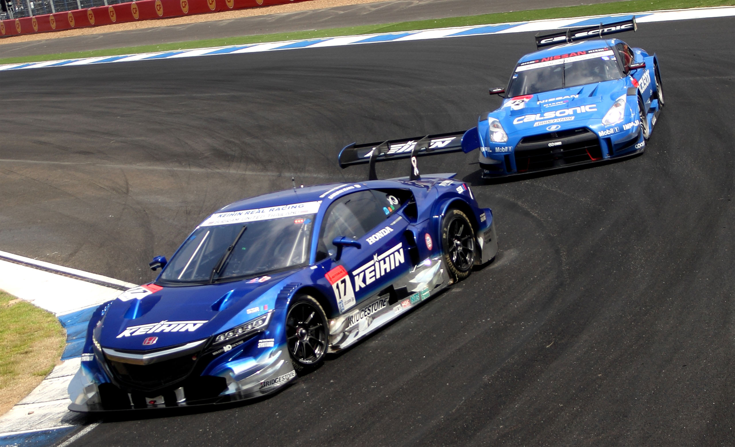 BURIRUM, THAILAND - 2014/10/05: Honda NSX CONCEPT-GT KEIHIN and Nisson GT-R CALSONIC IMPUL during practice session at Chang International Circuit in Burirum. Thailand's latest motor racing track, the Chang International Circuit (CIC) the first first FIA Grade 1 and FIM Grade A Circuit in Thailand, open with the Japanese Super GT. The track was designed by German engineer and auto racer Hermann Tilke with 4.554 kilometres long and consists of 12 corners. (Photo by Piti A Sahakorn/LightRocket via Getty Images)