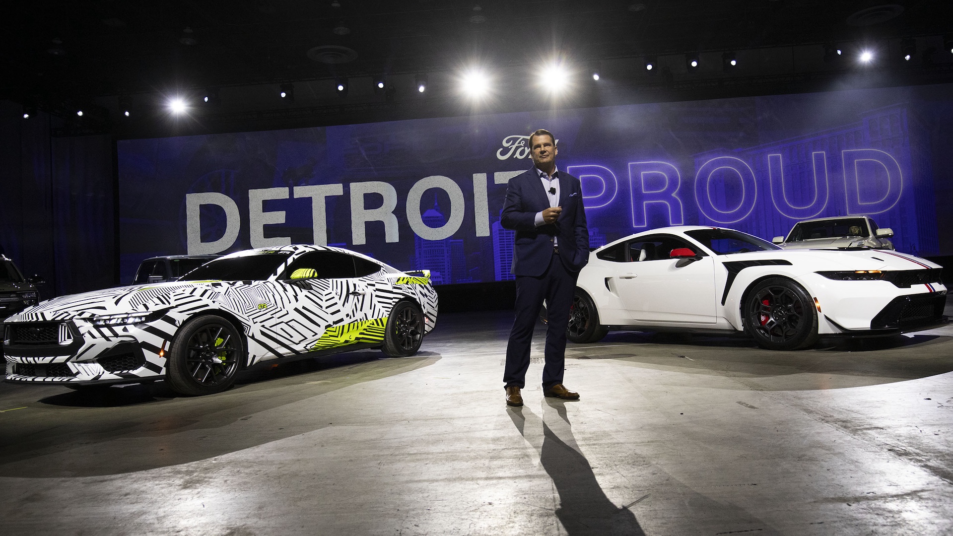 DETROIT, MICHIGAN - JANUARY 9: Ford Motor Company President and CEO Jim Farley stands between the Ford Mustang RTX (left) and the Ford Mustang GTD (right) at a Ford “Detroit Proud” event at the 2025 Detroit Auto Show at Huntington Place on January 9, 2025 in Detroit, Michigan. The Detroit Auto Show opens to the public on January 11th and runs through January 20th .(Photo by Bill Pugliano/Getty Images)