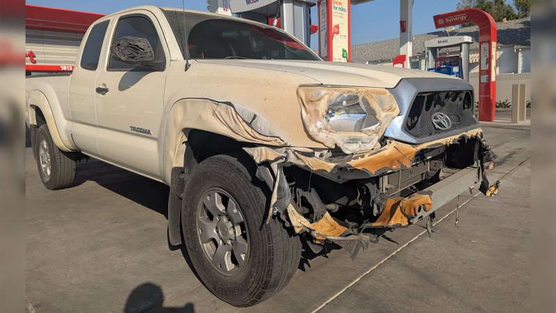 Image of Toyota Tacoma previously damaged in California wildfires parked at gas station.