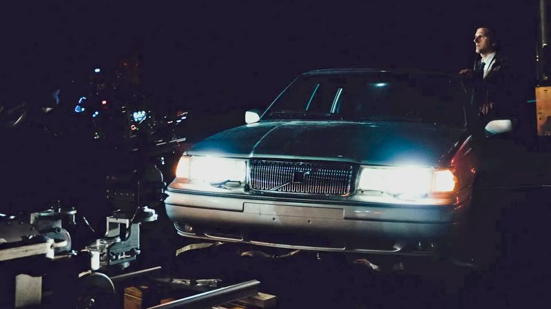 Adam Scott on the set of Severance with an old Volvo, behind the scenes.