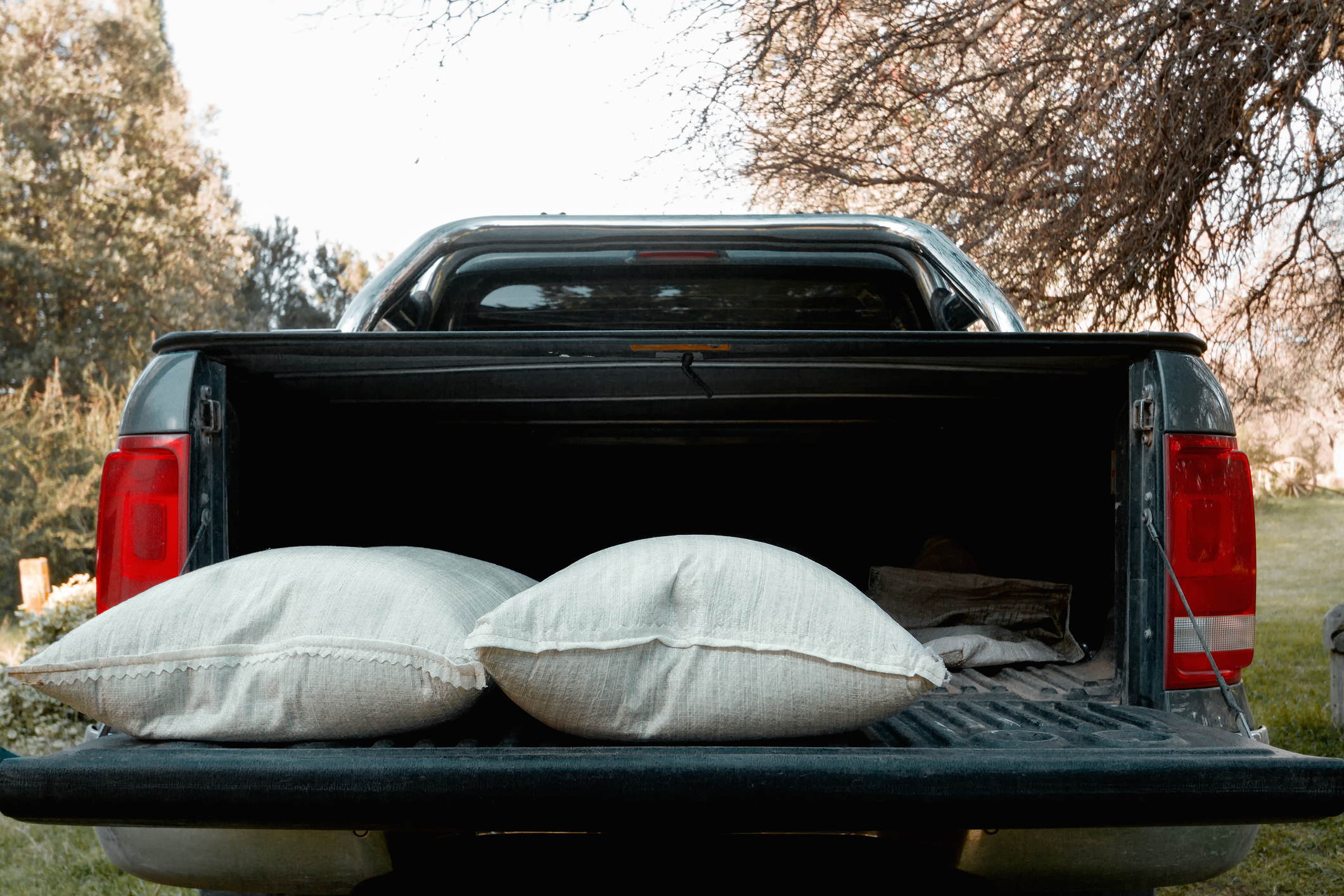Back of pick up truck with open cab and sandbags