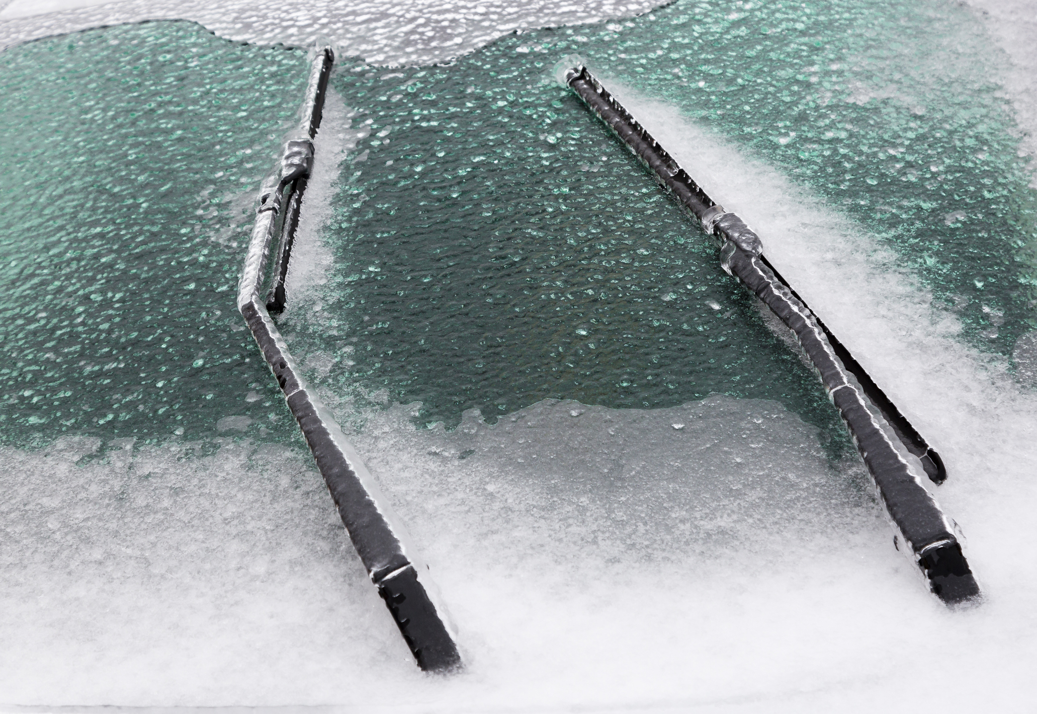 Car windshield covered with frost early in the morning