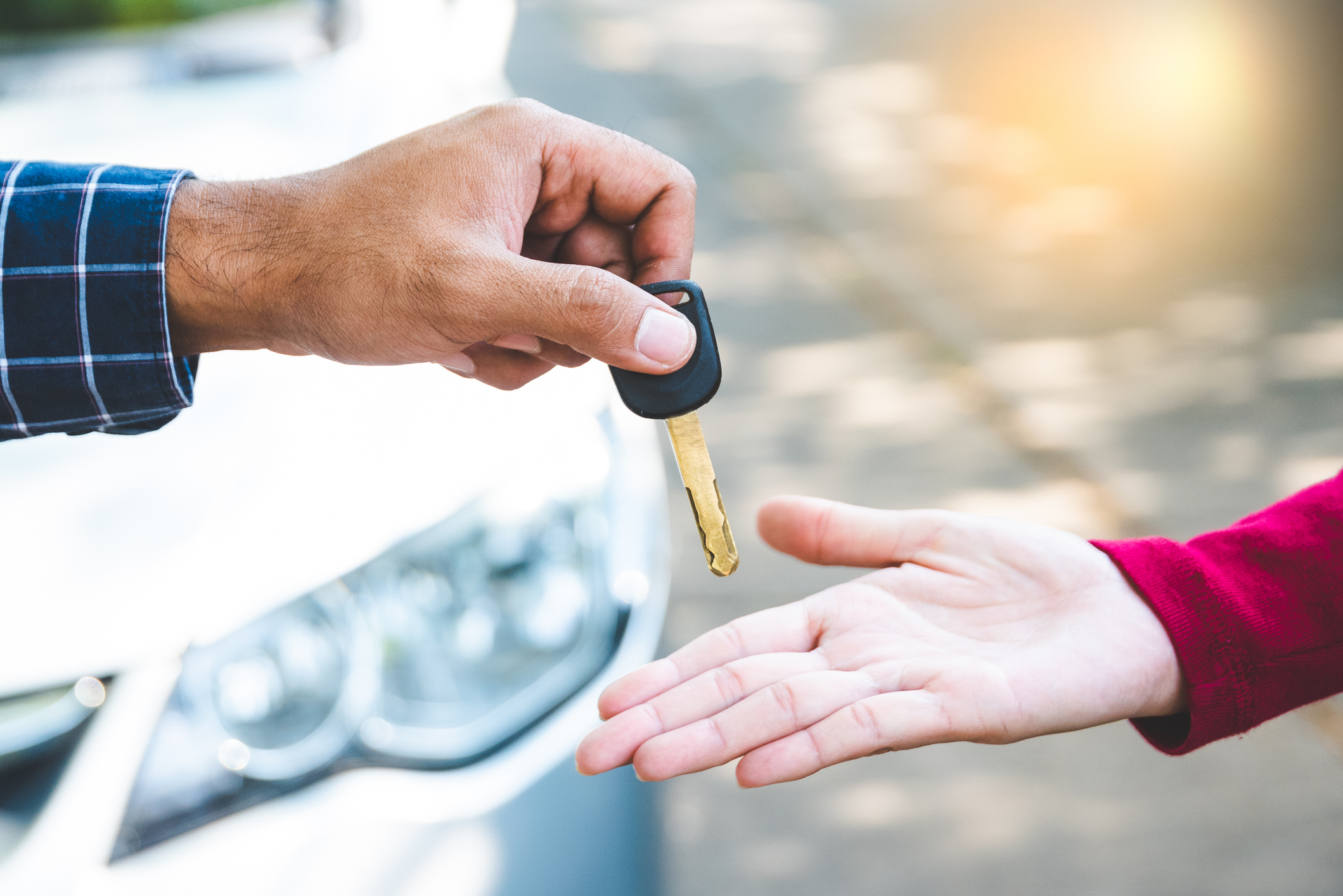 A man handing a woman some keys.