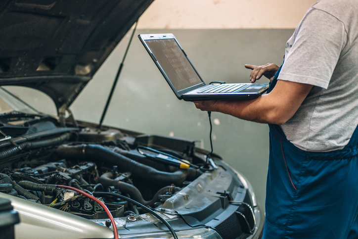 A person using a computer a monitor an engine's health