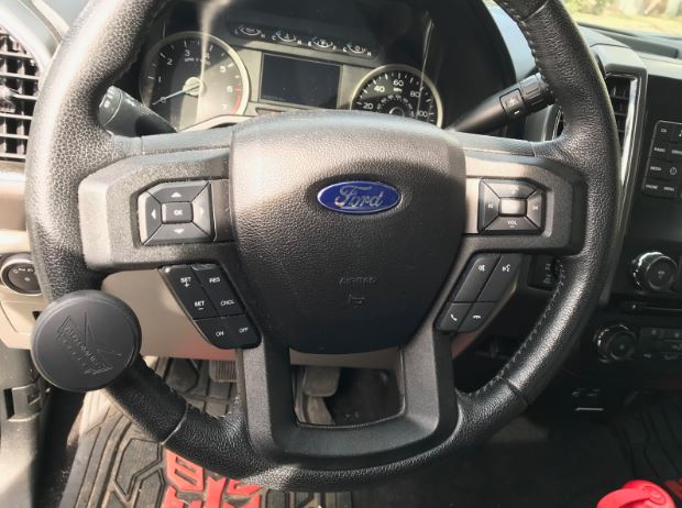 A brodie knob attached to a steering wheel.