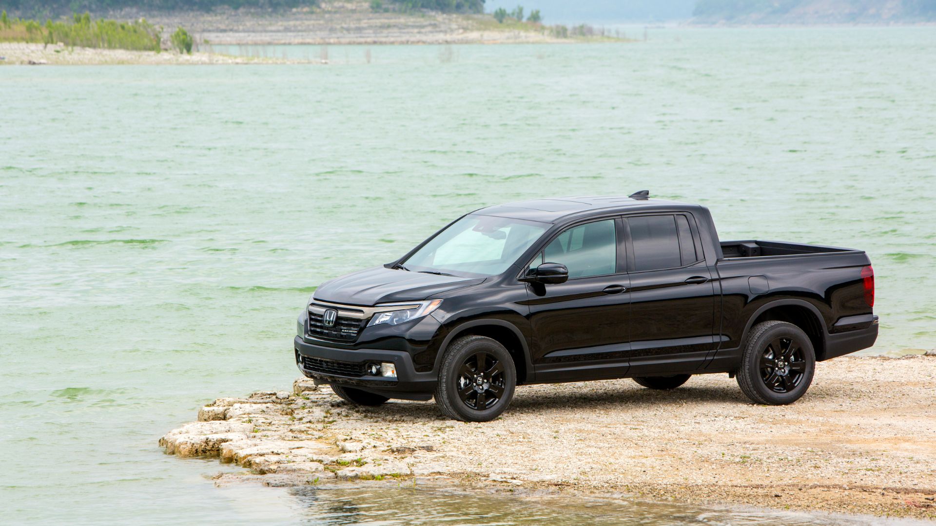 A 2020 Honda Ridgeline parked near a lake.