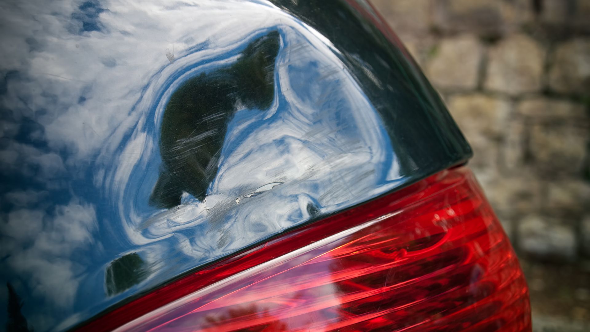 A small dent above a taillight. 