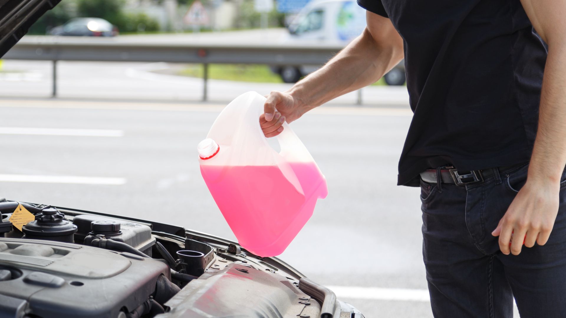 A man filling antifreeze.