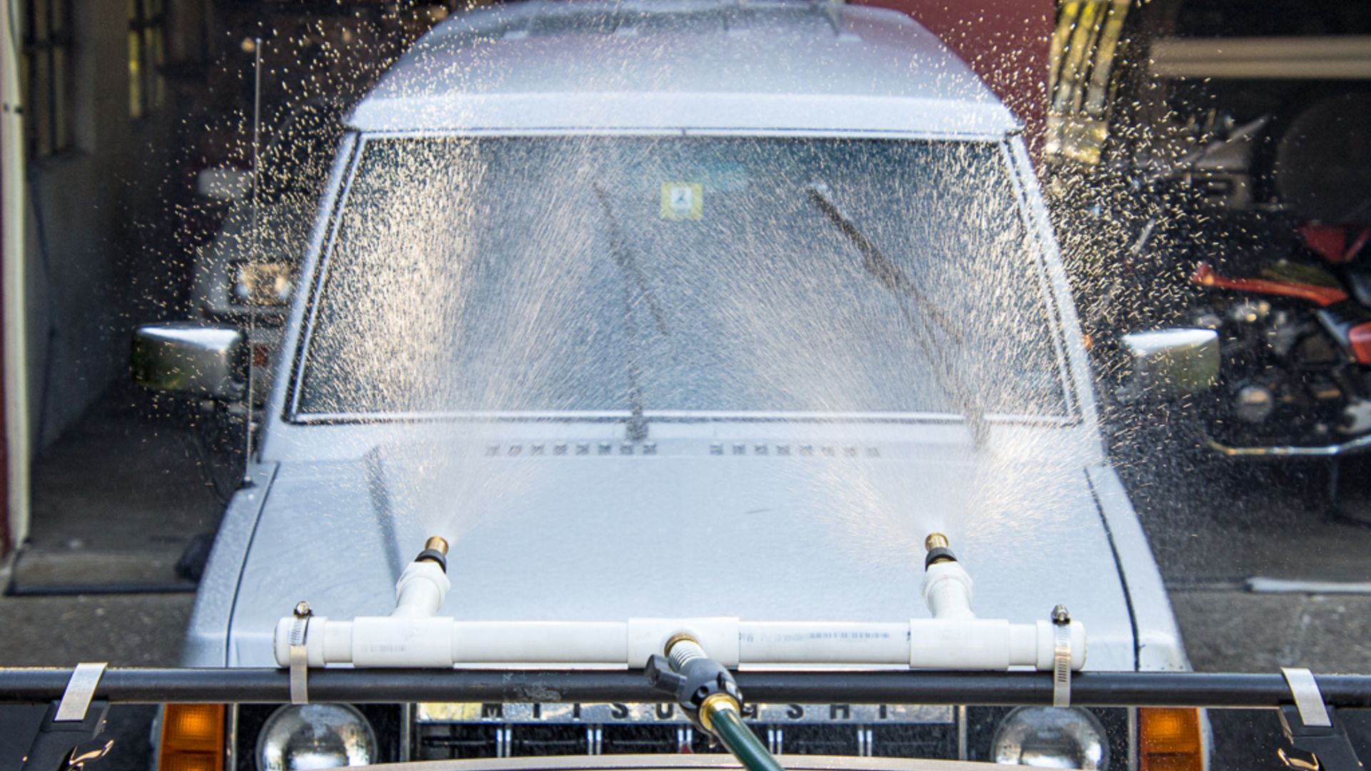 The rig spraying water at the Mitsubishi.