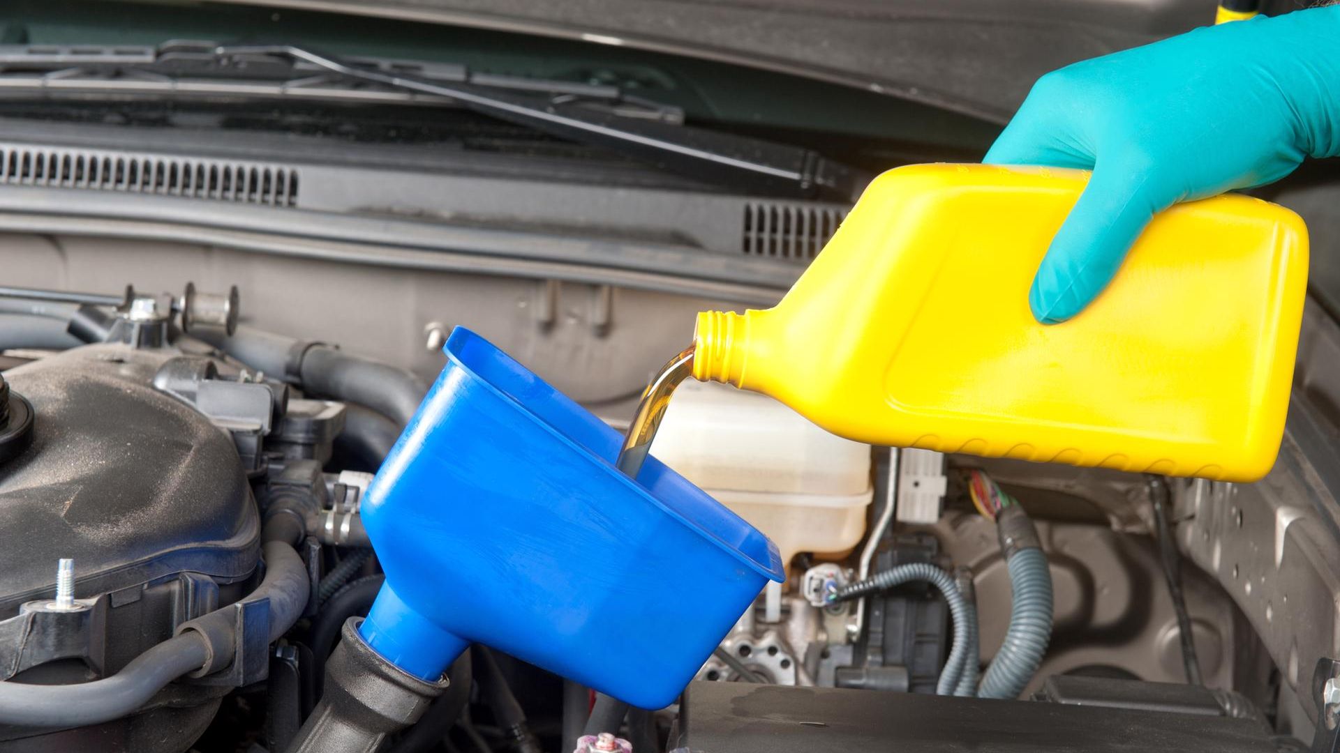 Motor oil being poured into an engine. 