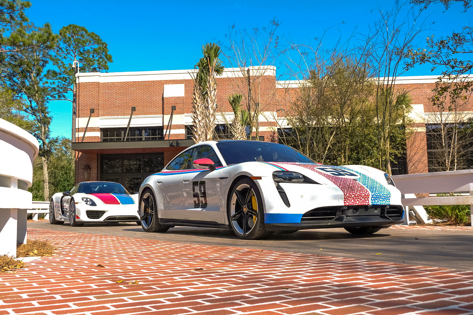 A Porsche Taycan and 918 Spyder. 