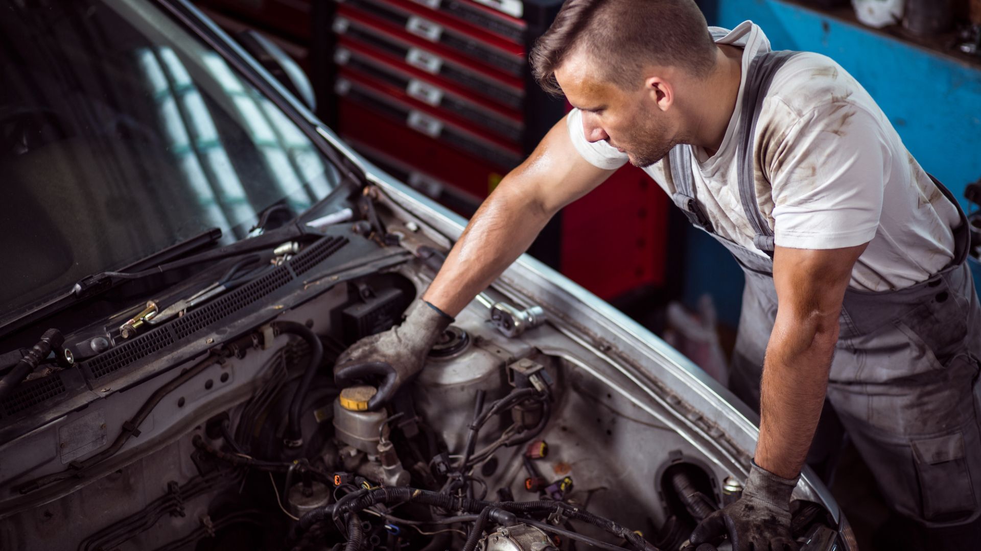 A mechanic checking the brake fluid level. 