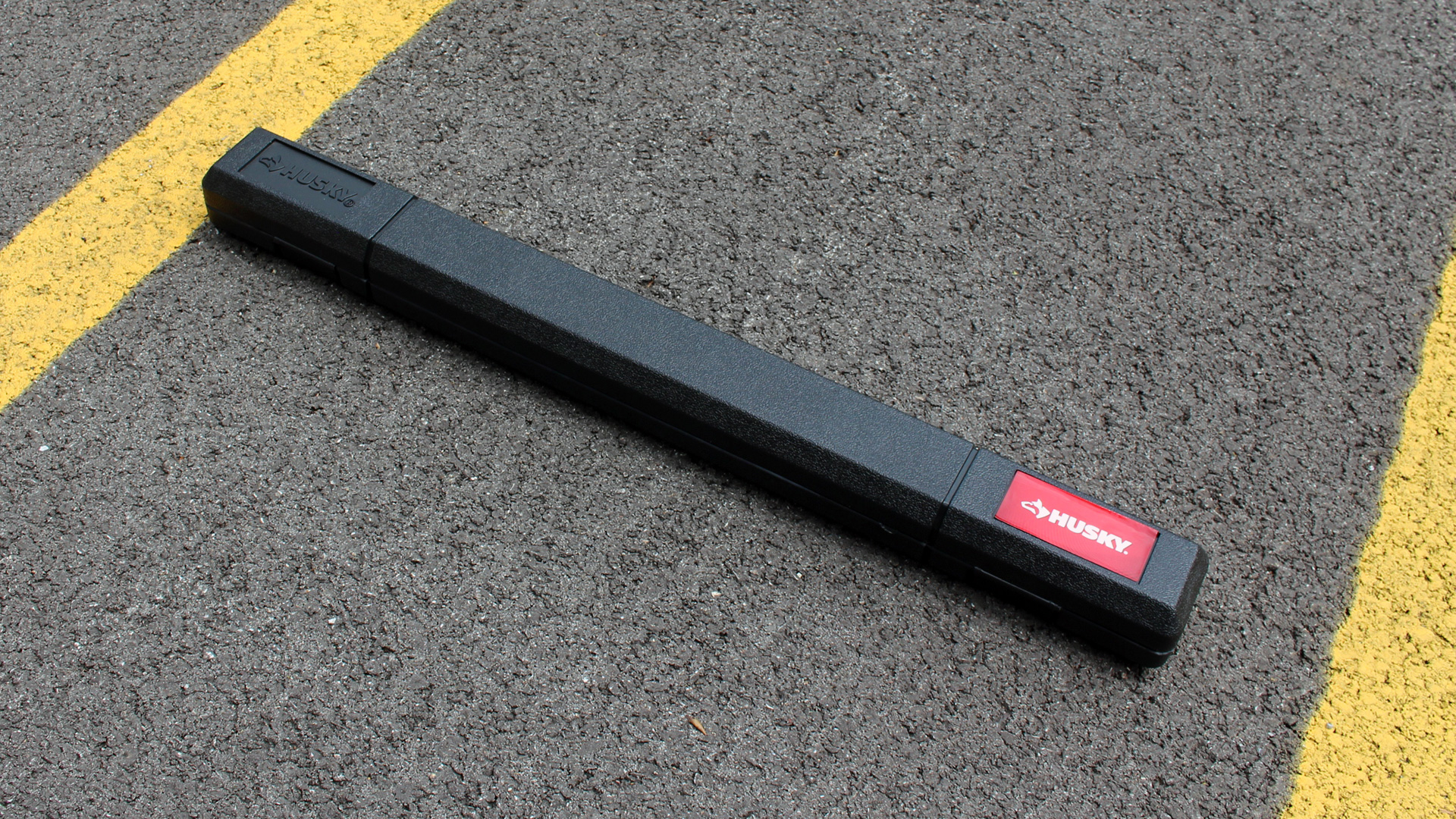 A Husky torque wrench with 1/2-inch Drive in its case on the ground.