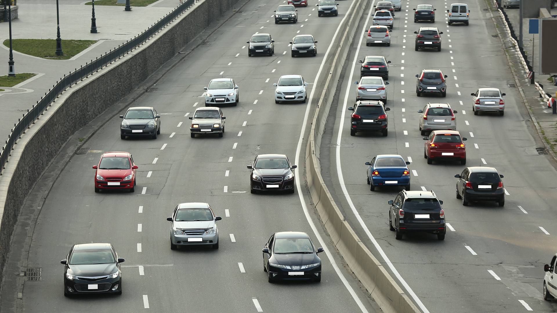 Spaced-out cars on a three-lane highway.