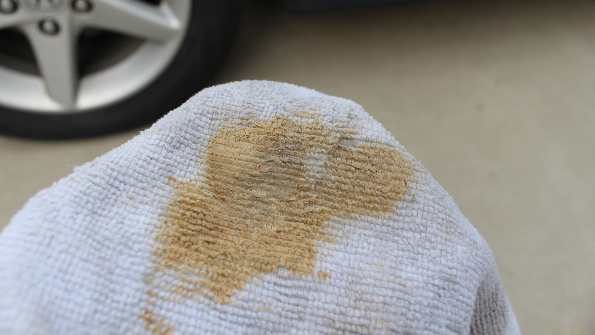 A close-up of a microfiber towel with polishing compound on it.