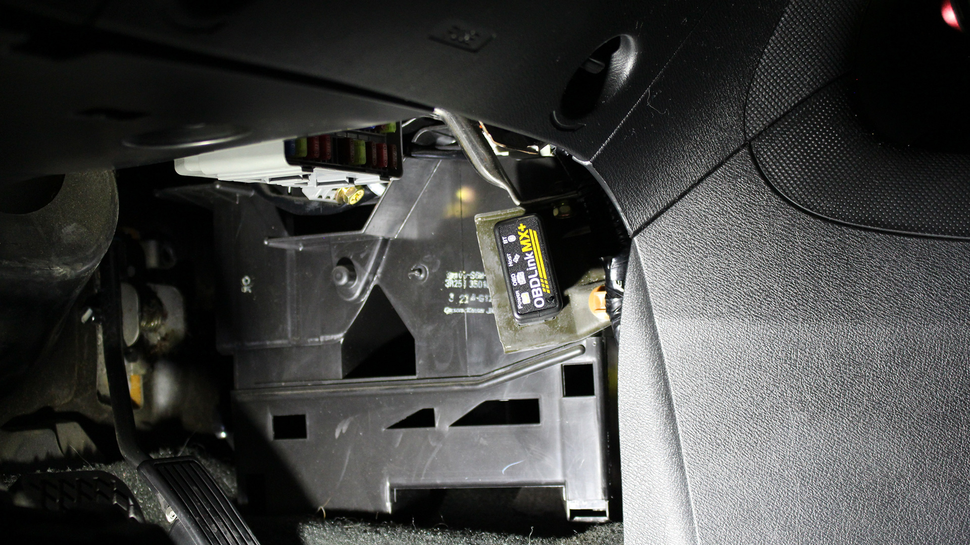 An OBDLink MX+ Bluetooth scanner is plugged into an Acura RSX OBD2 port.