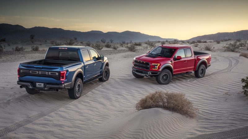 Watch a Rivian R1T Towing a Truck Drag Race a Ford F-150 Raptor