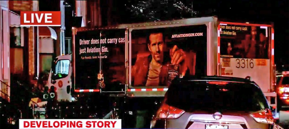 Truck Bearing Ryan Reynolds’s Smug Face Sideswipes Cars, Crashes Into House to Avoid Cat