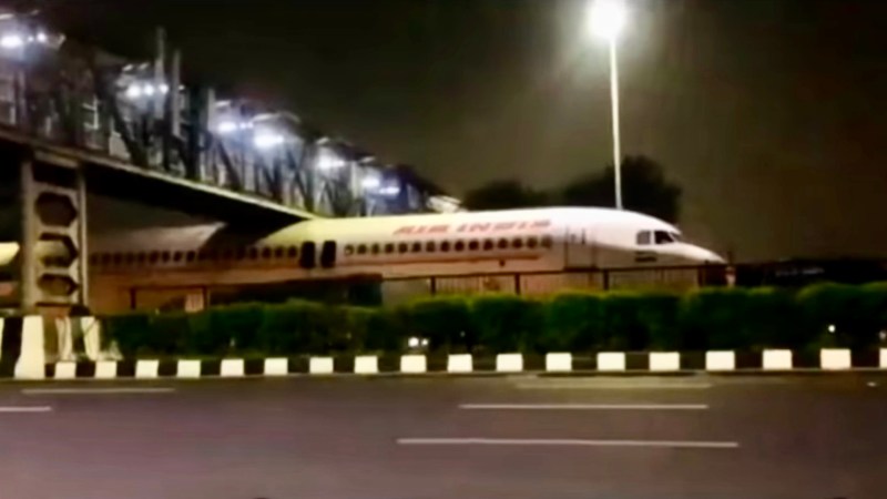 Scrapped Airliner Stuck Under Bridge in India